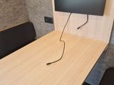 a desk with a monitor and a chair in front of it