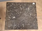 a picture of a marble table top on a wooden floor