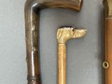 two old walking canes that are next to each other