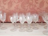 many wine glasses lined up on a table