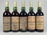 four bottles of old wine are lined up in a row