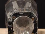 a clear glass vase on a wooden table with a black background