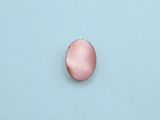 an image of a pink button sitting on top of a blue surface