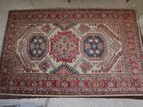 rug on the floor in a room with a white wall