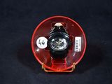 a watch sitting in a red case on a black surface