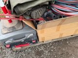a box full of assorted items sitting on the ground