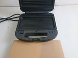 a black grill with a box on top of it