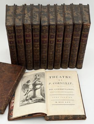 several old books sitting on top of each other on a table