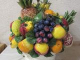 a vase with a bunch of fruit in it on a table