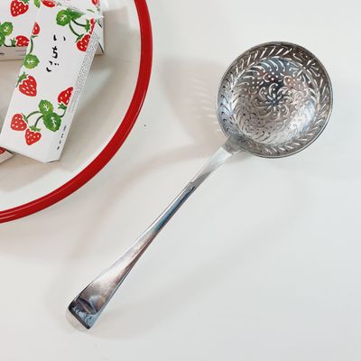 a piece of cake on a plate next to a measuring spoon