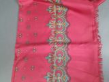 a close up of a pink scarf with a decorative design on it