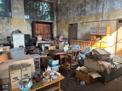 a room filled with lots of boxes and furniture