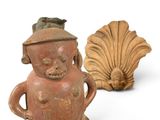 two figurines of a man and a shell on a white background