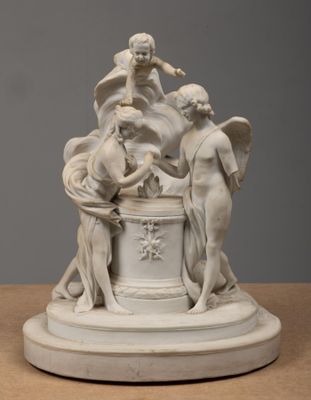 sculpture of a group of people on a pedestal on a table