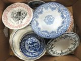 many plates in a box that are sitting in the box
