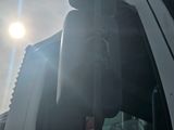 a picture of a car mirror with the sun in the background