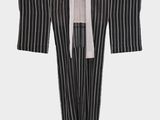 an image of a black and white striped robe hanging on a hanger