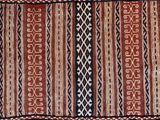 a red, black and white rug with a pattern on it
