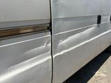 a white van that is parked on the side of the road