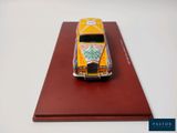 a yellow toy car on a red display board
