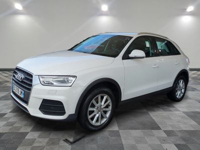 a white audi suv parked in a large room