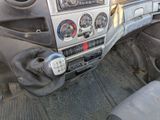 a dashboard of a truck with various gauges and controls
