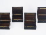 four small wooden boxes with brass trims and handles