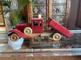 a red toy truck sitting on top of a glass table