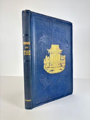 a blue book with a yellow cover sitting on top of a table
