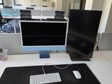 a computer desk with a keyboard and a monitor on it