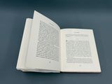 a book open on a table with a blue background