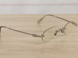 a pair of glasses sitting on a wooden table