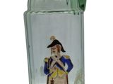 a green glass pitcher with a picture of a man on it