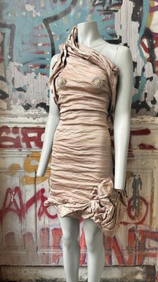 a mannequin wearing a dress with a flower on it