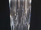 a glass vase that is sitting on a black surface