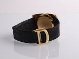 black leather watch band with gold d buckle on a white surface