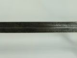 a sword that is on display on a white surface