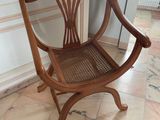 a wooden chair that is sitting on a tile floor