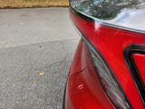 a red car parked on the side of the road
