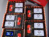 four boxes of red and black cars are sitting on a table