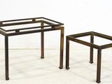 pair of metal and glass side tables in the shape of a coffee table