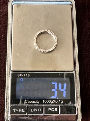 a silver scale with a ring on top of it