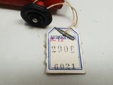 a red toy car with a price tag attached to it
