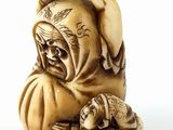 an image of a figurine of a man with a hat and a dog