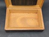 a wooden box that has a small radio inside of it