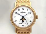 a gold wrist watch with a white dial and a gold bracelet
