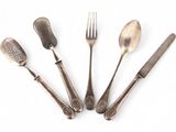 four forks and spoons are arranged in a circle on a white surface