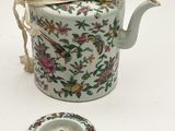 a tea pot and a plate on a white table