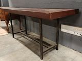 a table with a wooden top in a room
