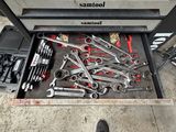 a man that is standing in front of a table with tools